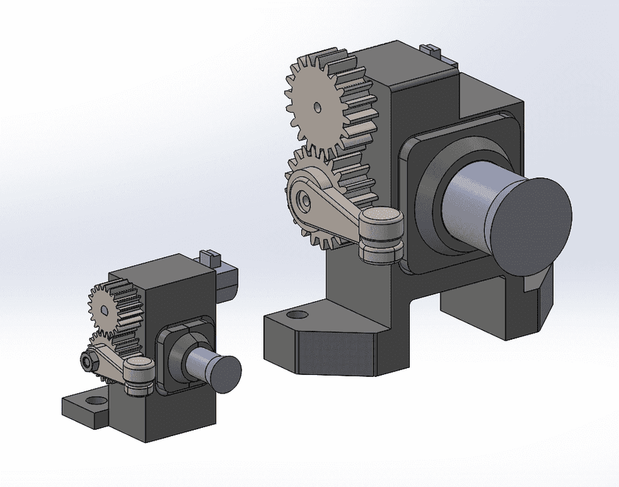 CAD render of the two release mechanism versions side by side, the compact redesign at left and the original at right.